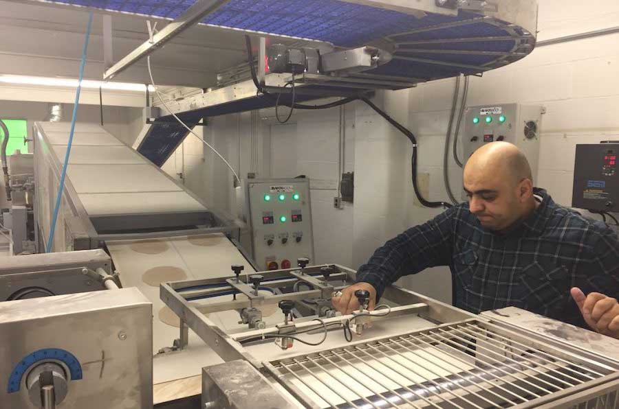 Firas Kazlee working in his shop