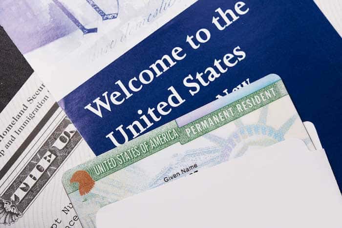 closeup of permanent resident card and brochures