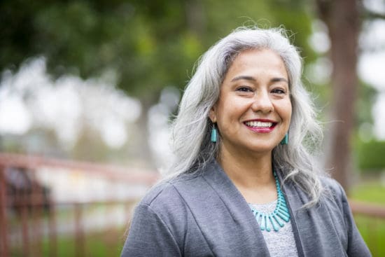 Happy-looking silver-haired woman wearing turquoise jewelry