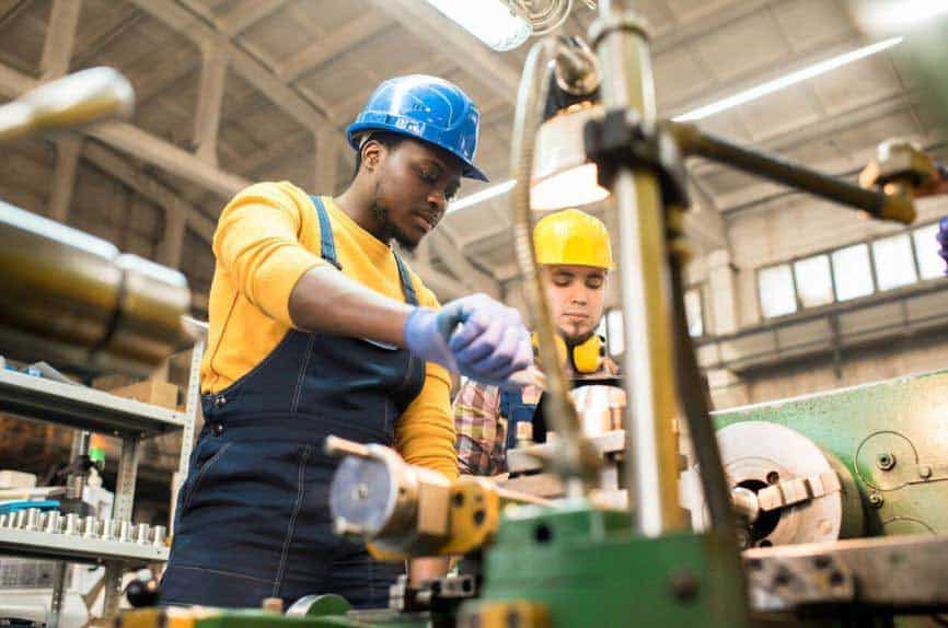 two men working on industrial machine in workshop