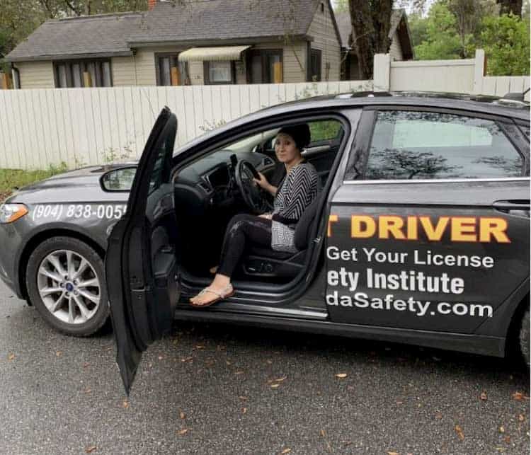 woman in the driver's seat of a black car