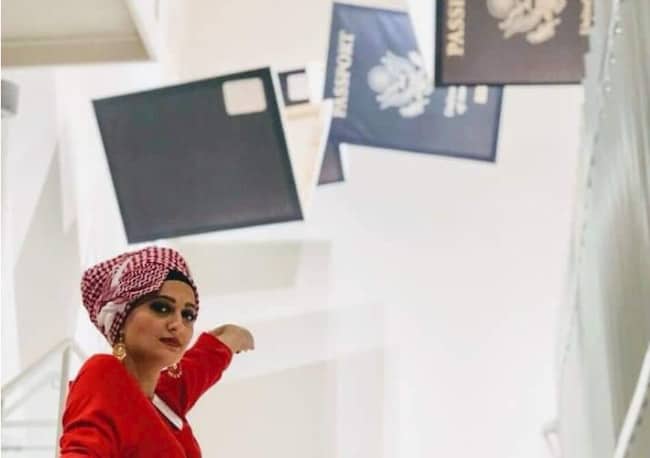 Basma Alawee in front of a visa display