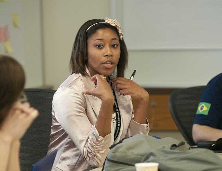 young woman in pink jacket in classroom